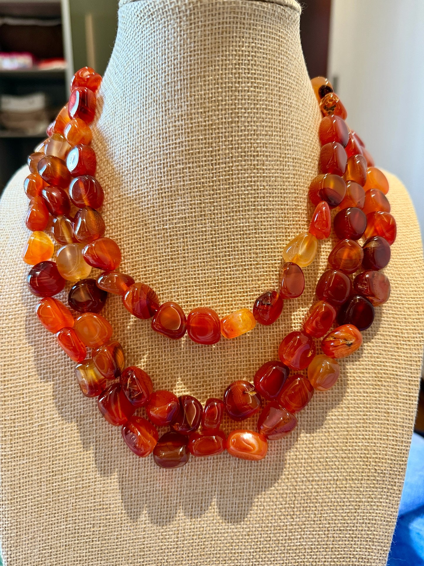 Riri Bespoke Jewelry multi-strand statement necklace featuring polished, tumbled carnelian gemstones in warm orange tones.