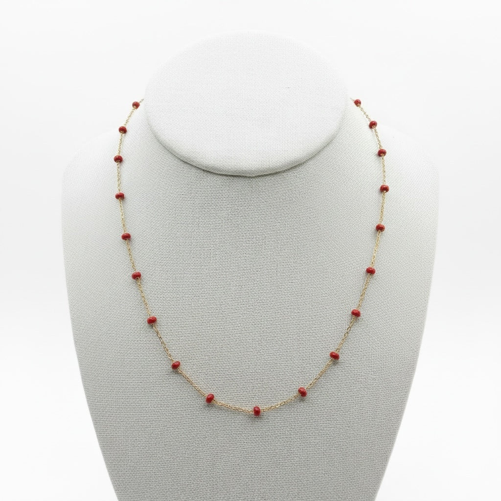 Riri Bespoke Jewelry delicate gold-tone chain necklace featuring evenly spaced bright red beads on a display bust