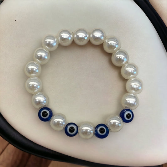 White imitation pearl bracelet with evil eye beads.