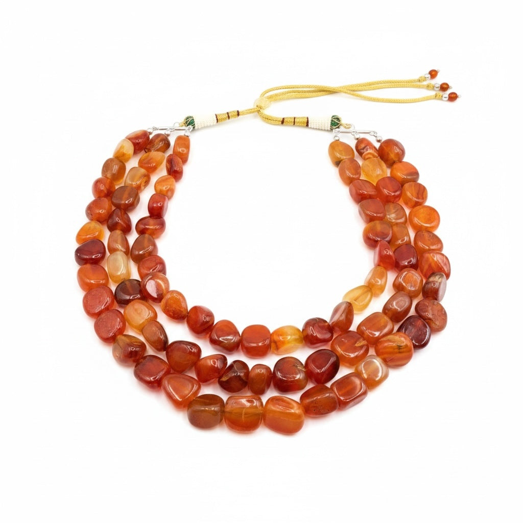 Riri Bespoke Jewelry multi-strand statement necklace featuring polished, tumbled carnelian gemstones in warm orange tones.