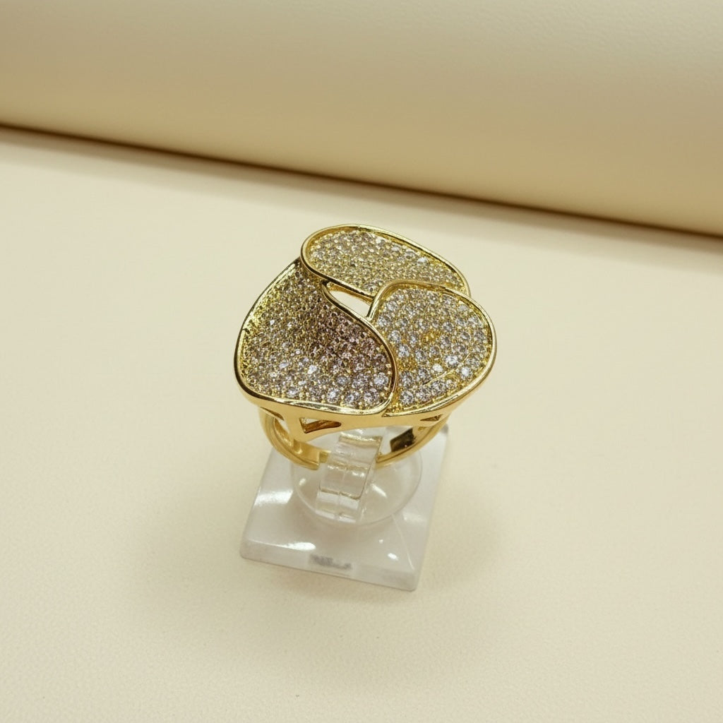 Riri Bespoke Jewelry gold-tone statement ring with a layered floral design and pavé-set clear crystals.