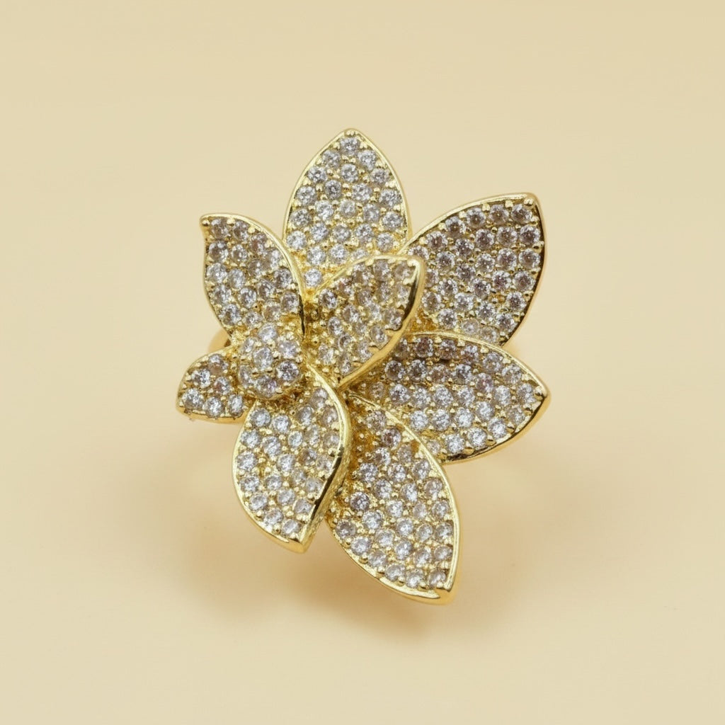 Riri Bespoke Jewelry gold-tone floral statement ring with layered petals encrusted in shimmering cubic zirconia stones