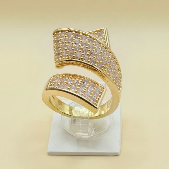 Riri Bespoke Jewelry gold-tone geometric statement ring with cubic zirconia stones in a wrap-around open design.