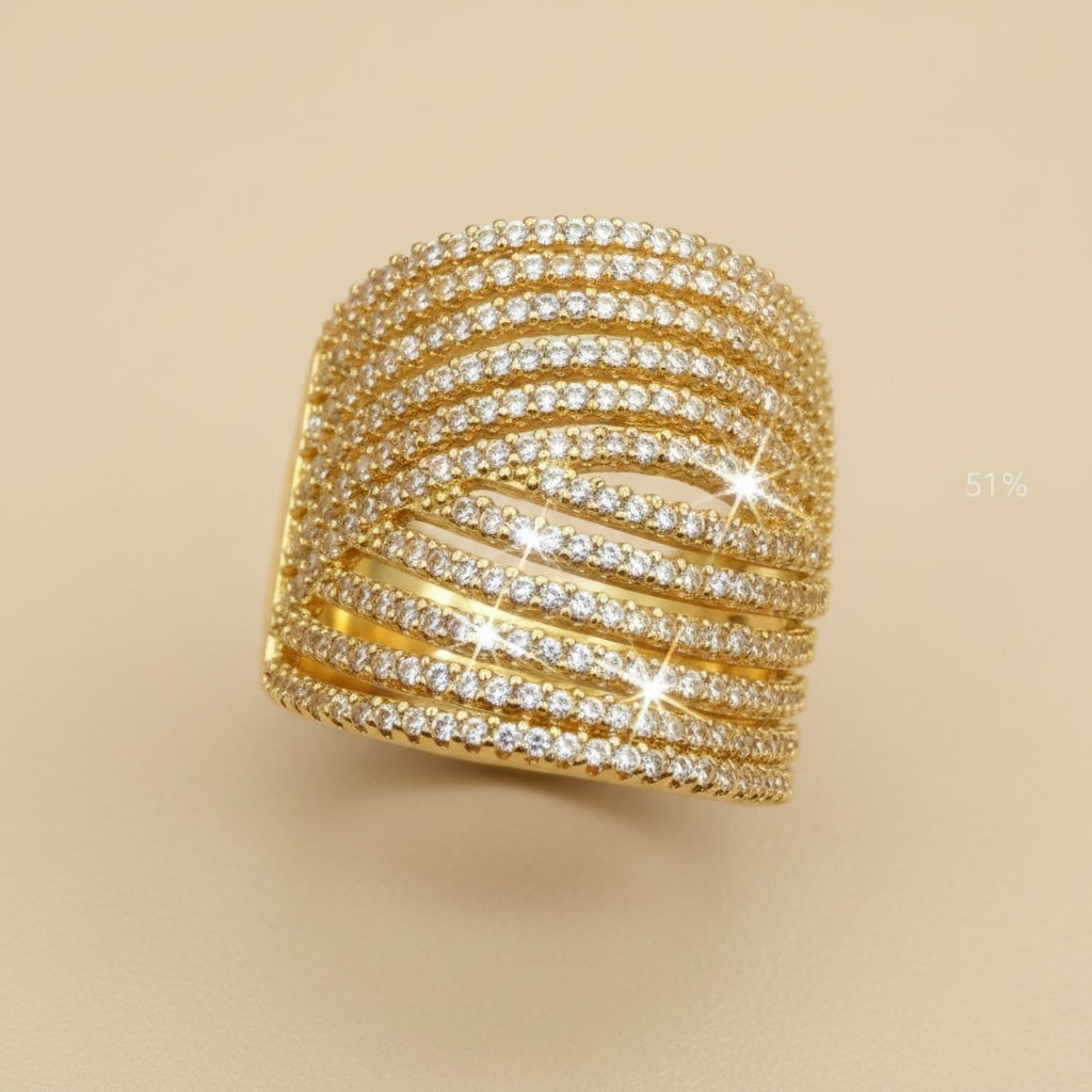 Riri Bespoke Jewelry gold-tone multi-row statement ring featuring shimmering cubic zirconia stones on a wide band.