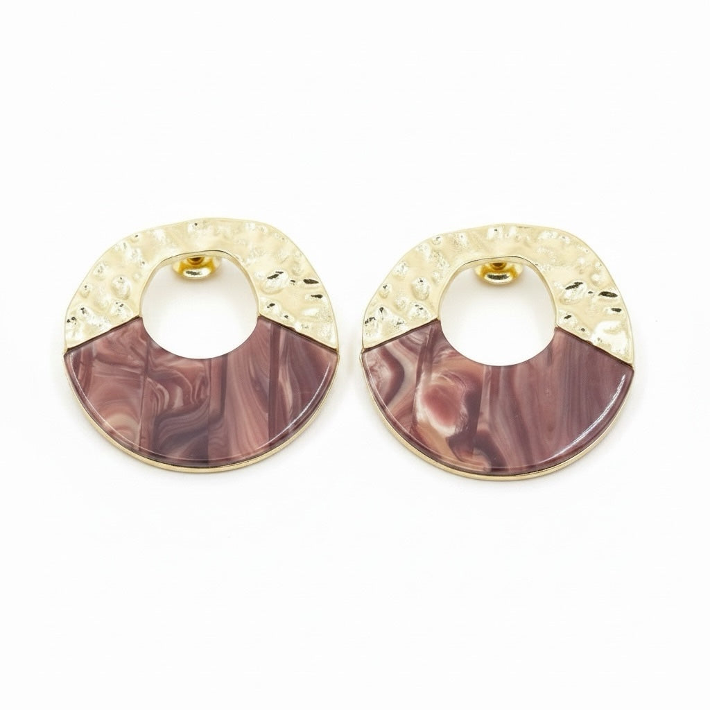 Riri Bespoke Jewelry circular stud earrings featuring hammered gold-tone metal and marbled mauve resin accents.