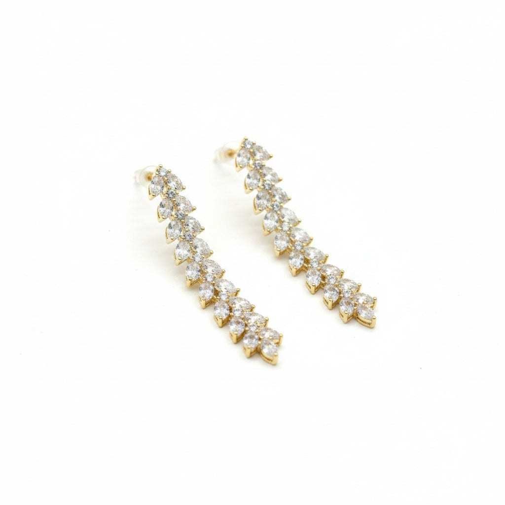 Riri Bespoke Jewelry marquise-cut crystal drop earrings in a gold-tone vine silhouette on a white background.