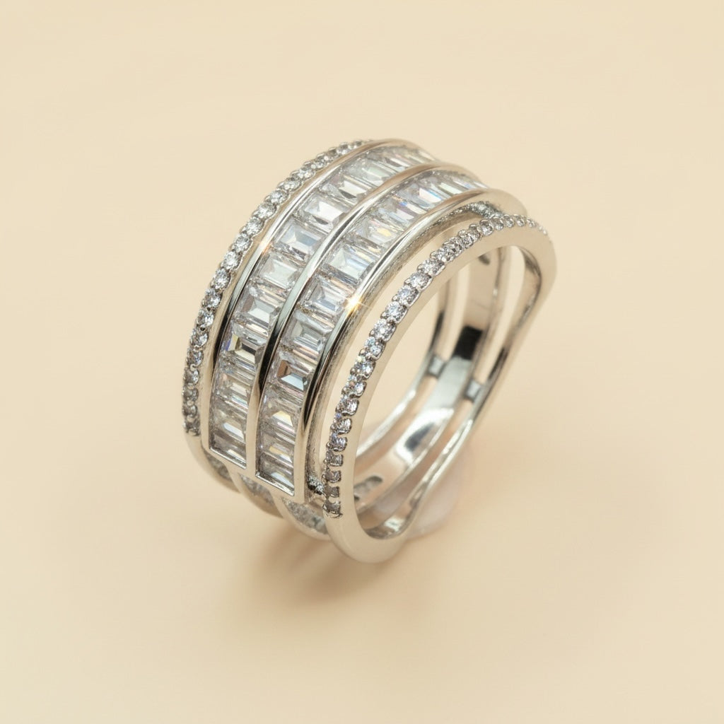 Riri Bespoke Jewelry multi-row statement ring featuring baguette-cut stones and pavé-set bands in polished silver-tone.