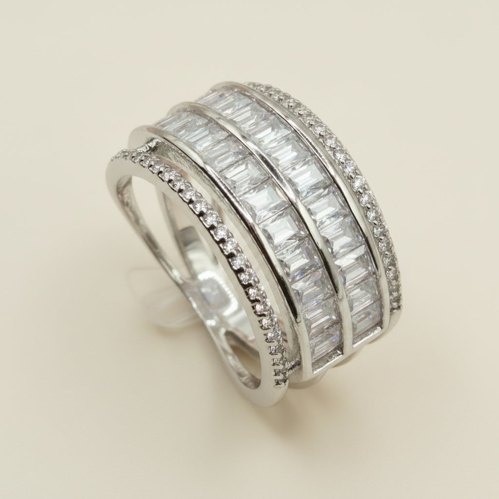 Riri Bespoke Jewelry multi-row statement ring with baguette-cut and pavé stones in a polished silver-tone finish.